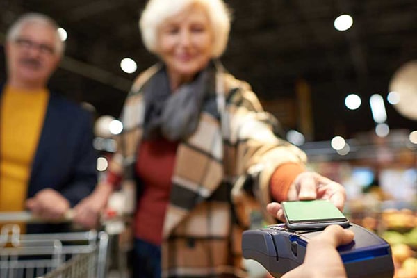 A woman paying with her phone