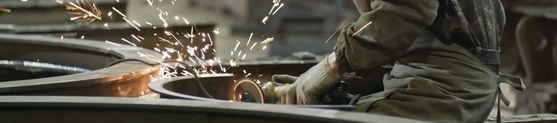 Man grinding metal, polishing rough edges