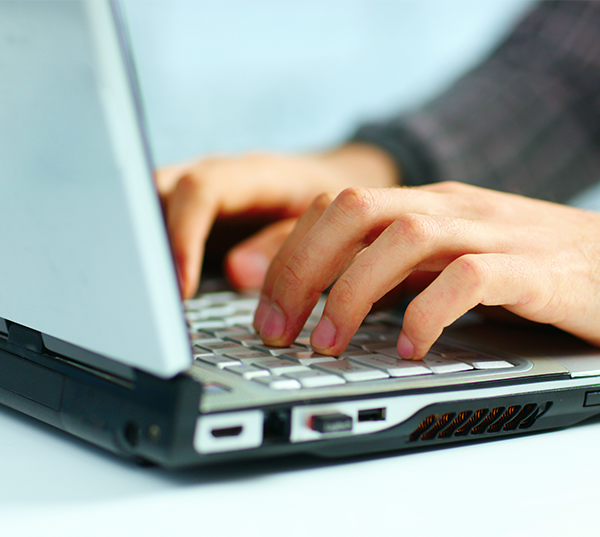 hands typing on laptop with words on image saying Slow Down, Think before you click