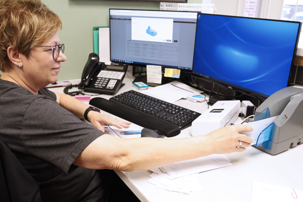 Woman using desktop scanner